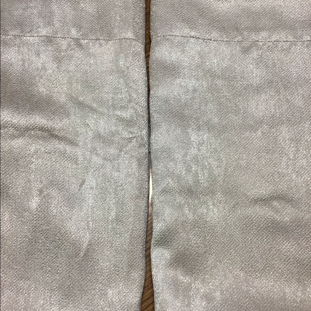 Drapes a pair (2 total ) of cream colored drapes